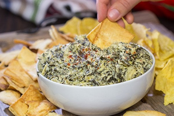 This Slow Cooker Spinach Artichoke Dip is a party favorite!  It only takes a few minutes to mix, and then the slow cooker does the rest!