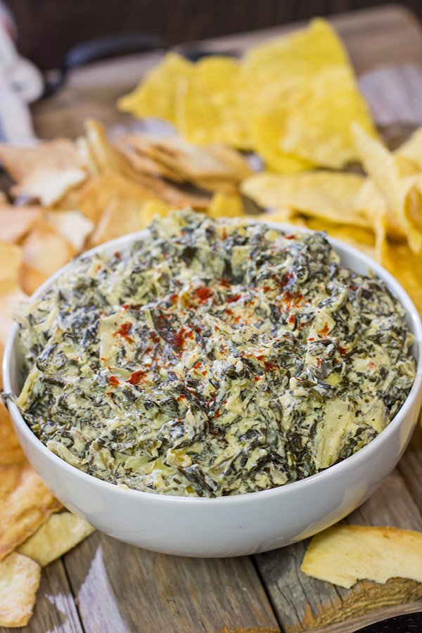 This Slow Cooker Spinach Artichoke Dip is a party favorite!  It only takes a few minutes to mix, and then the slow cooker does the rest!