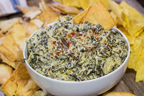This Slow Cooker Spinach Artichoke Dip is a party favorite!  It only takes a few minutes to mix, and then the slow cooker does the rest!