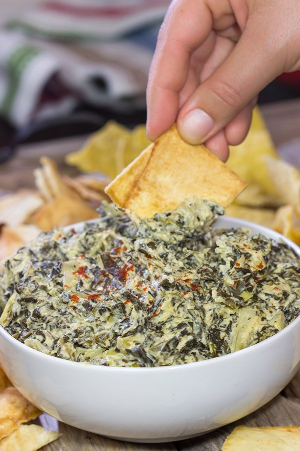 This Slow Cooker Spinach Artichoke Dip is a party favorite!  It only takes a few minutes to mix, and then the slow cooker does the rest!