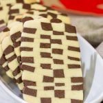 Featuring a fun "woven" look, these Basketweave Cookies are a delicious combination of vanilla and chocolate shortbread cookies.  Bake up a batch today!