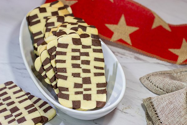 Featuring a fun "woven" look, these Basketweave Cookies are a delicious combination of vanilla and chocolate shortbread cookies.  Bake up a batch today!