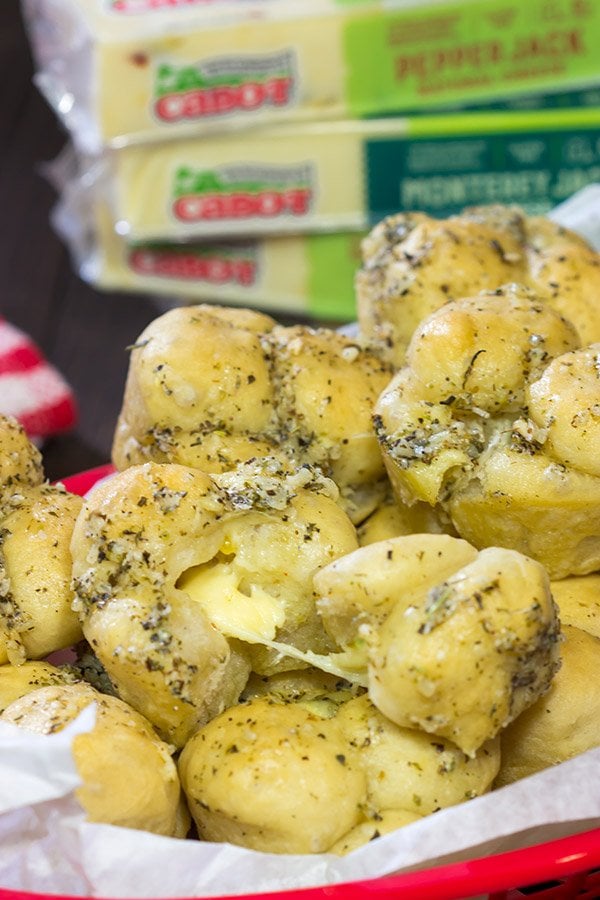 Take a good garlic knot and make it better...by adding cheese!  These Cheesy Muffin Tin Garlic Knots are a fun and tasty snack.  They're sure to become a family favorite!