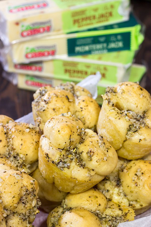Take a good garlic knot and make it better...by adding cheese!  These Cheesy Muffin Tin Garlic Knots are a fun and tasty snack.  They're sure to become a family favorite!