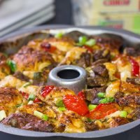 Packed with juicy steak, sauteed peppers + onions and two types of cheese, this Philly Cheesesteak Monkey Bread is one delicious way to mix up the routine!