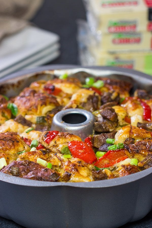 Packed with juicy steak, sauteed peppers + onions and two types of cheese, this Philly Cheesesteak Monkey Bread is one delicious way to mix up the routine!