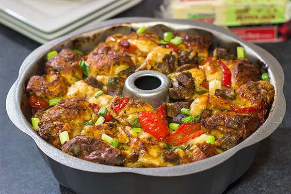 Packed with juicy steak, sauteed peppers + onions and two types of cheese, this Philly Cheesesteak Monkey Bread is one delicious way to mix up the routine!