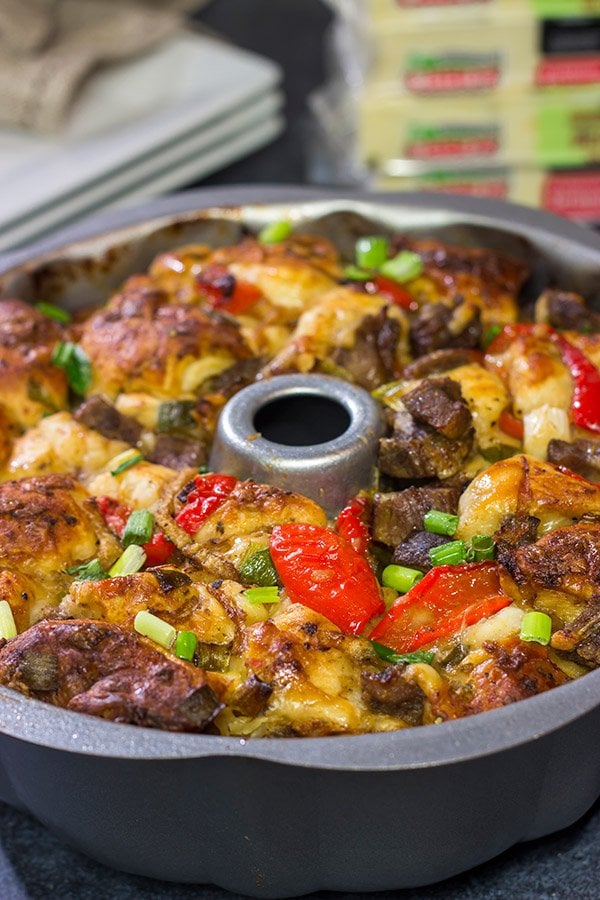 Packed with juicy steak, sauteed peppers + onions and two types of cheese, this Philly Cheesesteak Monkey Bread is one delicious way to mix up the routine!