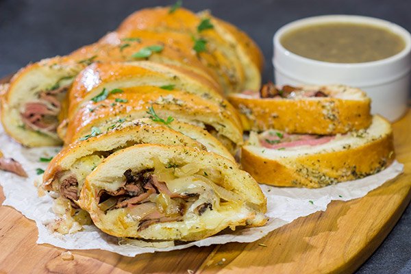 A good French Dip sandwich is hard to beat...unless you stuff it inside of garlic bread! This French Dip Stuffed Garlic Bread is a comfort food favorite!