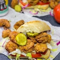 These Fried Shrimp Po'boys are a classic Louisiana sandwich!  A hunk of French bread topped with Cajun fried shrimp, creamy remoulade sauce and shredded lettuce is hard to beat!