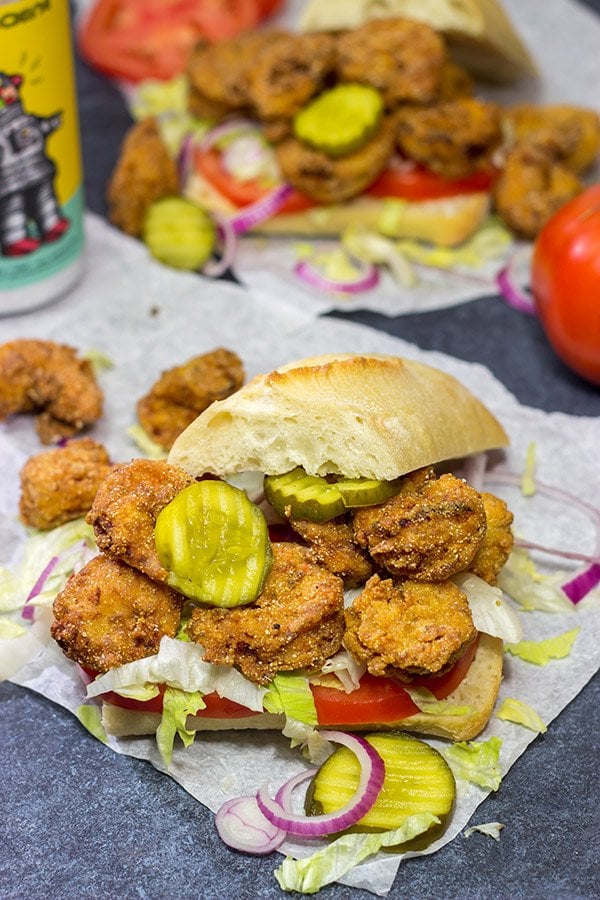 These Fried Shrimp Po'boys are a classic Louisiana sandwich!  A hunk of French bread topped with Cajun fried shrimp, creamy remoulade sauce and shredded lettuce is hard to beat!