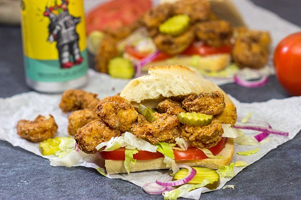 These Fried Shrimp Po'boys are a classic Louisiana sandwich!  A hunk of French bread topped with Cajun fried shrimp, creamy remoulade sauce and shredded lettuce is hard to beat!