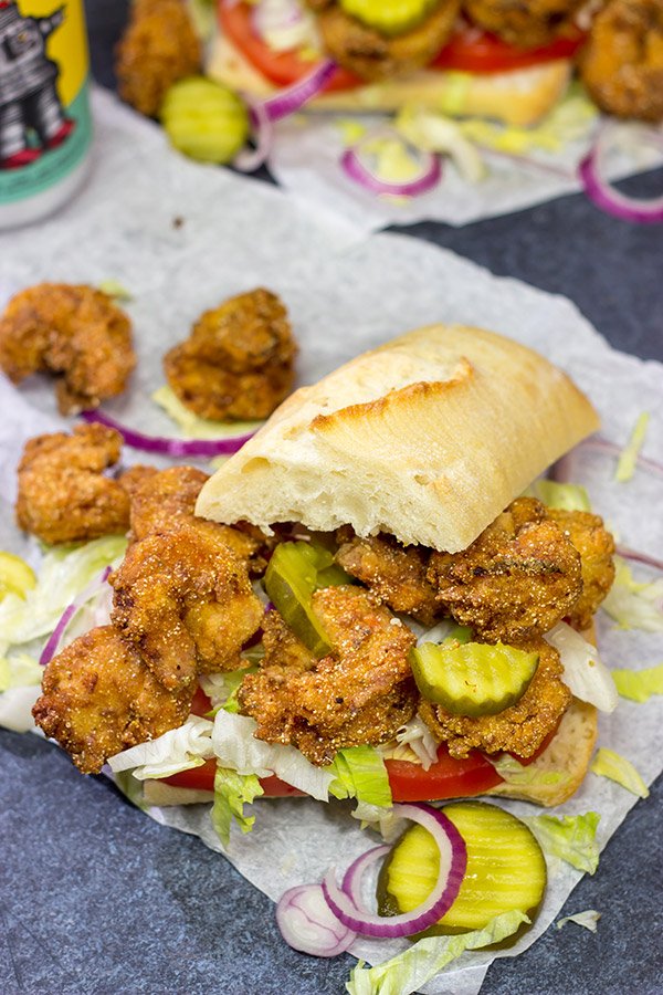These Fried Shrimp Po'boys are a classic Louisiana sandwich!  A hunk of French bread topped with Cajun fried shrimp, creamy remoulade sauce and shredded lettuce is hard to beat!