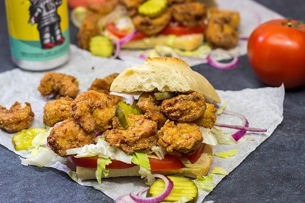 These Fried Shrimp Po'boys are a classic Louisiana sandwich!  A hunk of French bread topped with Cajun fried shrimp, creamy remoulade sauce and shredded lettuce is hard to beat!
