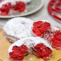 These Red Velvet Donuts are a fun way to put a festive spin on the classic baked powdered sugar donuts. Bake up a batch for Valentine's Day!