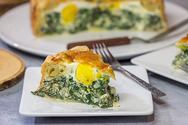 Torta Pasqualina is a traditional Italian recipe served at Easter. This delicious pie features a puff pastry crust stuffed with spinach, ricotta and eggs - yum!