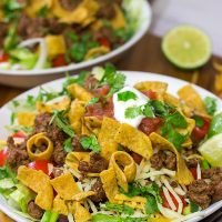 This Ground Beef Taco Salad is easy and delicious! This classic recipe is ready in just 15 minutes...just don't eat all of the Fritos first!
