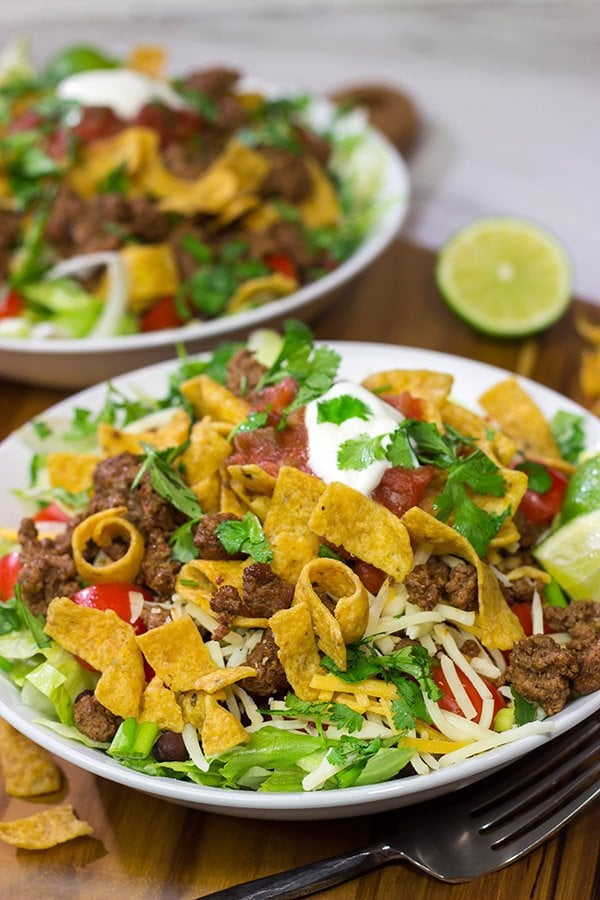 This Ground Beef Taco Salad is easy and delicious!  This classic recipe is ready in just 15 minutes...just don't eat all of the Fritos first!