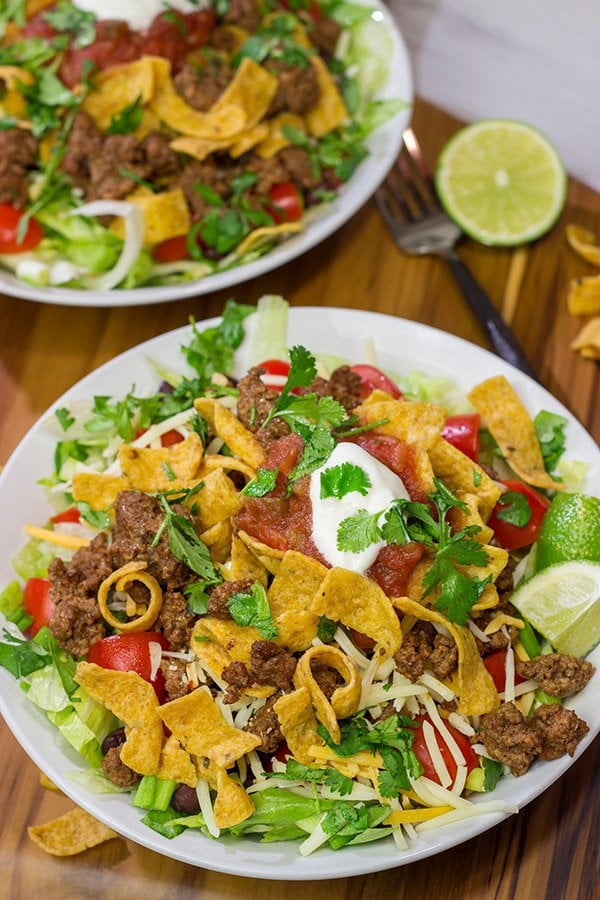 This Ground Beef Taco Salad is easy and delicious! This classic recipe is ready in just 15 minutes...just don't eat all of the Fritos first!