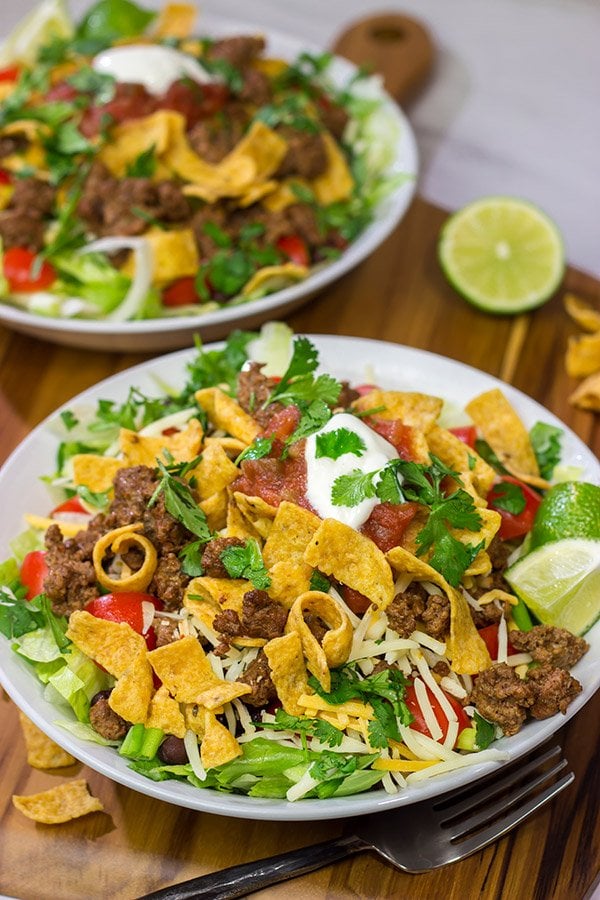 This Ground Beef Taco Salad is easy and delicious! This classic recipe is ready in just 15 minutes...just don't eat all of the Fritos first!