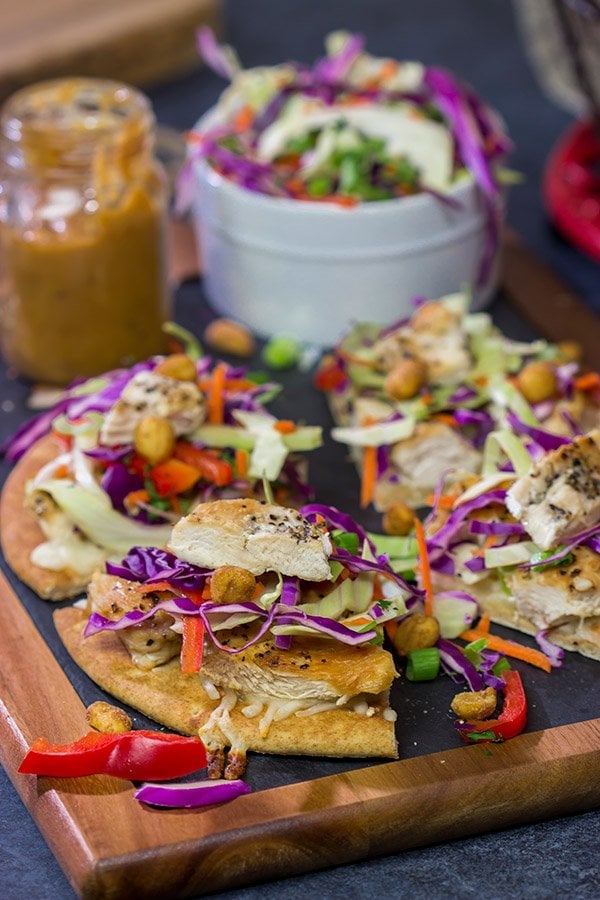 These Thai Chicken Flatbreads are a fun and colorful appetizer or main course!  They get topped with a tasty peanut sauce for extra flavor.