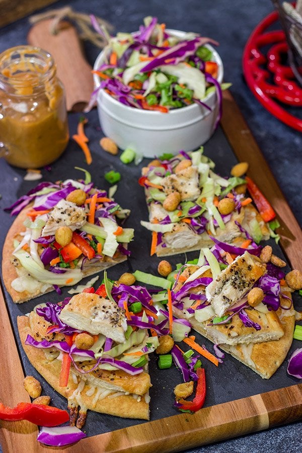 These Thai Chicken Flatbreads are a fun and colorful appetizer or main course! They get topped with a tasty peanut sauce for extra flavor.