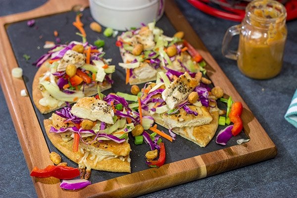 These Thai Chicken Flatbreads are a fun and colorful appetizer or main course! They get topped with a tasty peanut sauce for extra flavor.