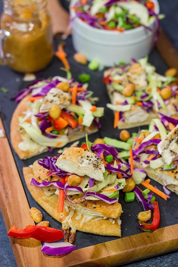 These Thai Chicken Flatbreads are a fun and colorful appetizer or main course! They get topped with a tasty peanut sauce for extra flavor.
