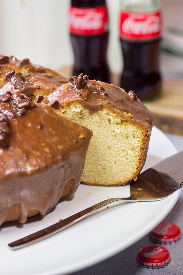 Topped with a chocolate glaze, this Coca Cola Pound Cake is a unique dessert idea!  Grab a slice today!
