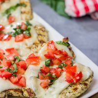 This Grilled Bruschetta Chicken is an easy recipe that's packed with flavor. It's perfect for dinner in the backyard on a warm summer night!