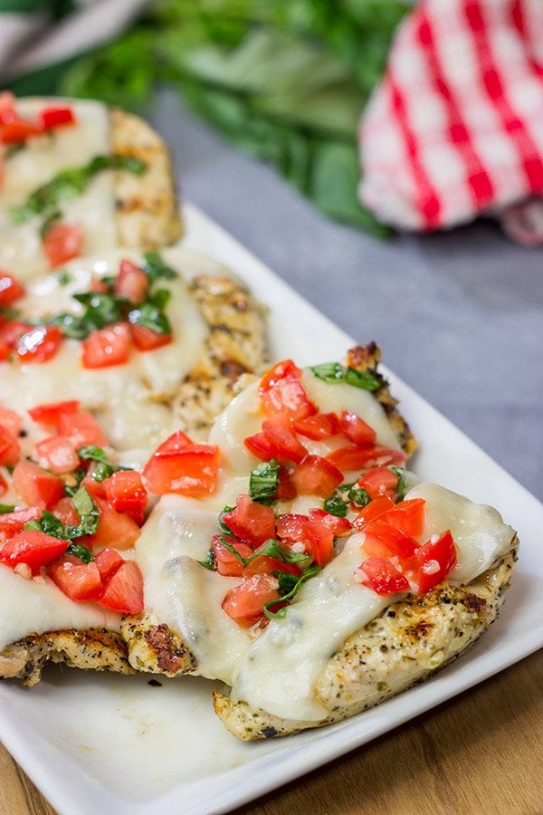This Grilled Bruschetta Chicken is an easy recipe that's packed with flavor. It's perfect for dinner in the backyard on a warm summer night!