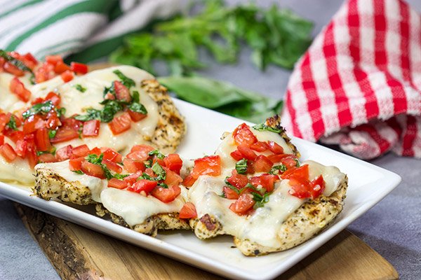 This Grilled Bruschetta Chicken is an easy recipe that's packed with flavor.  It's perfect for dinner in the backyard on a warm summer night!