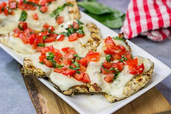 This Grilled Bruschetta Chicken is an easy recipe that's packed with flavor.  It's perfect for dinner in the backyard on a warm summer night!
