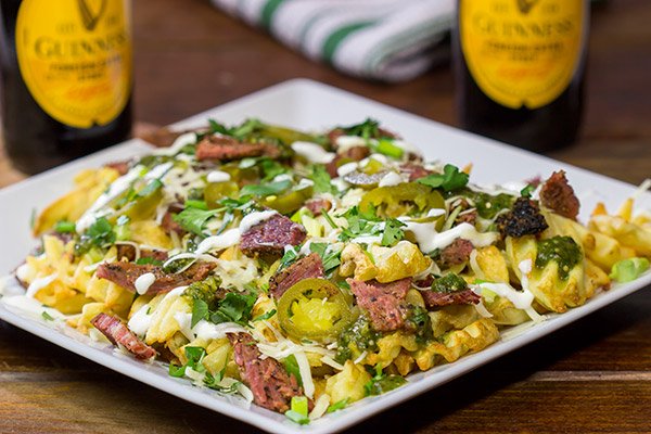 Get into the St. Patrick's Day spirit with a batch of these Irish Nachos - waffle fries loaded with cheese, salsa verde and chopped corned beef!