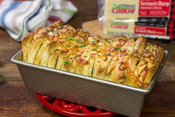 Looking for a fun (and tasty!) bread recipe? Bake up a loaf of this Cheesy Garlic Pull Apart Bread...and then have fun peeling off layer after layer of cheesy bread!