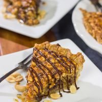 Love salty + sweet desserts? Then grab a handful of peanuts and chocolate chips and bake up this Chocolate Peanut Pie today!