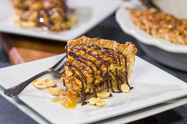 Love salty + sweet desserts?  Then grab a handful of peanuts and chocolate chips and bake up this Chocolate Peanut Pie today!