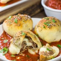 Put a twist on classic meatballs - by stuffing 'em with mozzarella! These Mozzarella Stuffed Meatball Bites are a fun combination of meatballs and pizza!