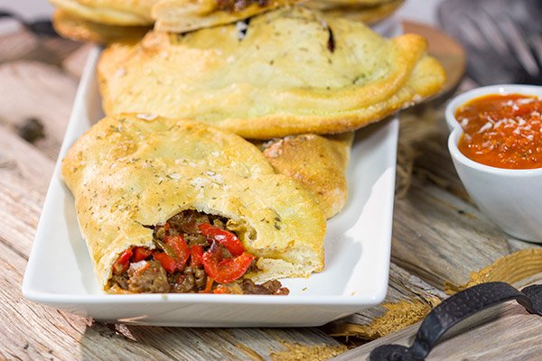 Looking for some tasty comfort food? Grab some pizza dough and make this Sausage and Peppers Calzone for dinner tonight!