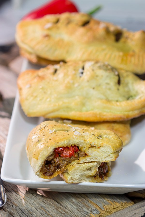Looking for some tasty comfort food? Grab some pizza dough and make this Sausage and Peppers Calzone for dinner tonight!