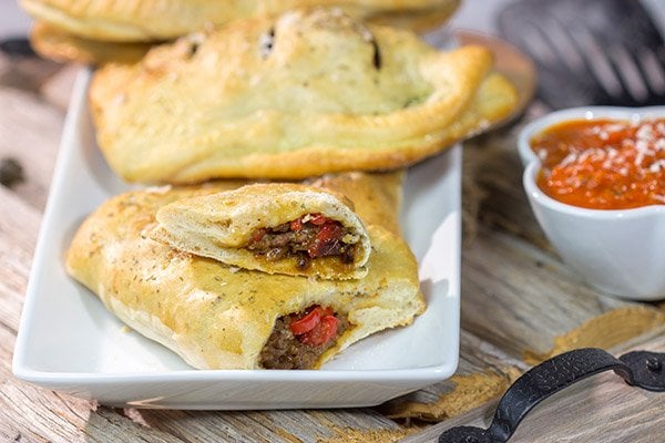 Looking for some tasty comfort food? Grab some pizza dough and make this Sausage and Peppers Calzone for dinner tonight!