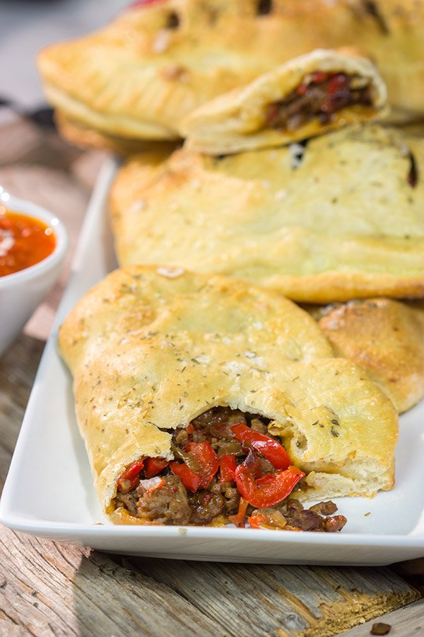 Looking for some tasty comfort food? Grab some pizza dough and make this Sausage and Peppers Calzone for dinner tonight!