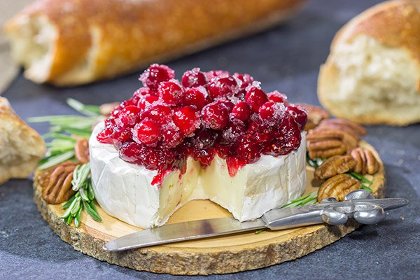 Looking for a unique holiday appetizer? This Brie with Cranberry Sauce is an easy but impressive appetizer to make - it's perfect for holiday get-togethers!