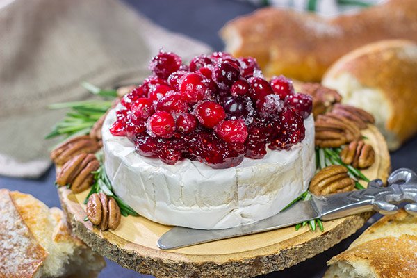 Looking for a unique holiday appetizer? This Brie with Cranberry Sauce is an easy but impressive appetizer to make - it's perfect for holiday get-togethers!
