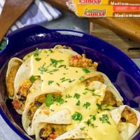 Want to break out of the 'dinner rut'? Then put these Cheesy Baked Burritos on the menu! Topped with an easy, homemade cheese sauce, these burritos are the perfect comfort food for chilly days!