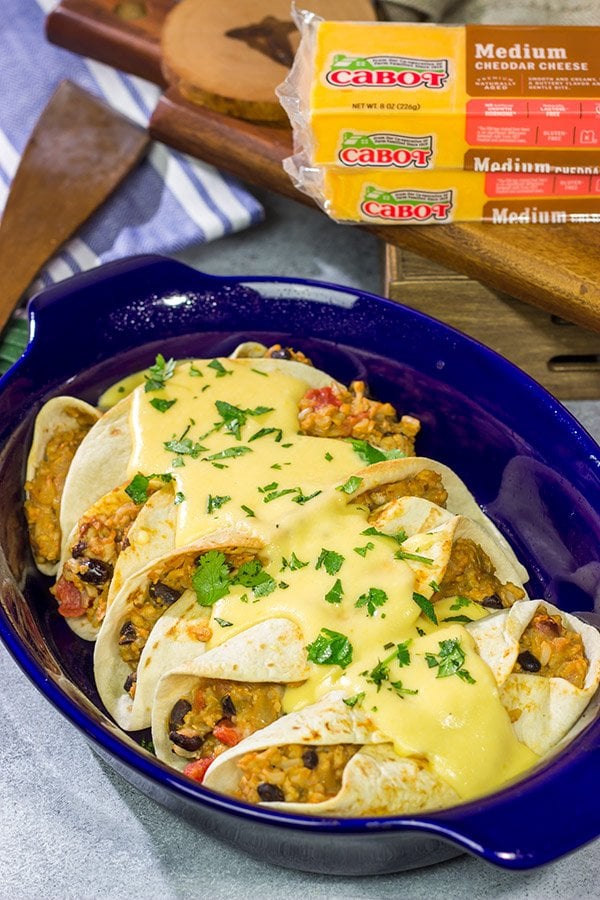 Want to break out of the 'dinner rut'? Then put these Cheesy Baked Burritos on the menu! Topped with an easy, homemade cheese sauce, these burritos are the perfect comfort food for chilly days!
