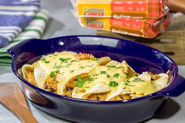 Want to break out of the 'dinner rut'? Then put these Cheesy Baked Burritos on the menu! Topped with an easy, homemade cheese sauce, these burritos are the perfect comfort food for chilly days!