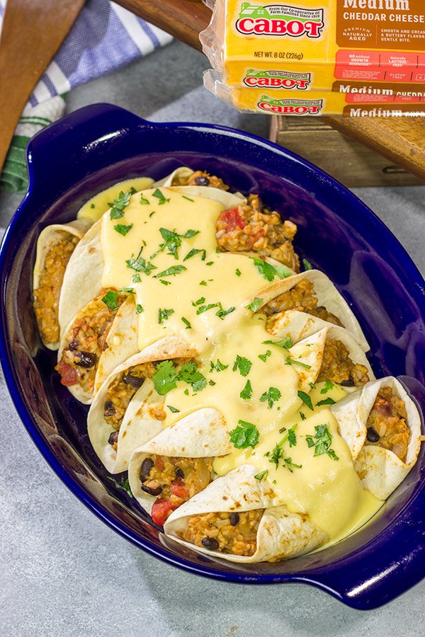 Want to break out of the 'dinner rut'? Then put these Cheesy Baked Burritos on the menu! Topped with an easy, homemade cheese sauce, these burritos are the perfect comfort food for chilly days!