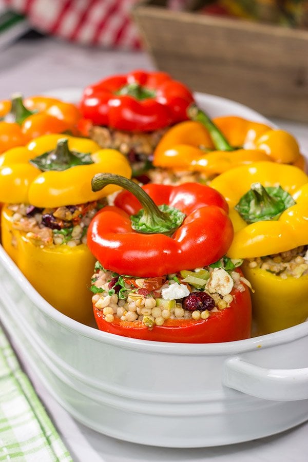 Looking for a tasty way to shake the winter blues? Put these Couscous Stuffed Peppers on the dinner menu! Packed with Mediterranean flavor, these peppers were a huge hit in our house!