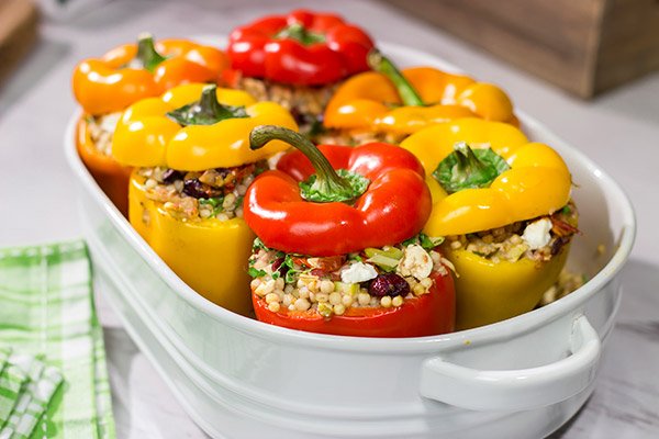 Looking for a tasty way to shake the winter blues? Put these Couscous Stuffed Peppers on the dinner menu! Packed with Mediterranean flavor, these peppers were a huge hit in our house!